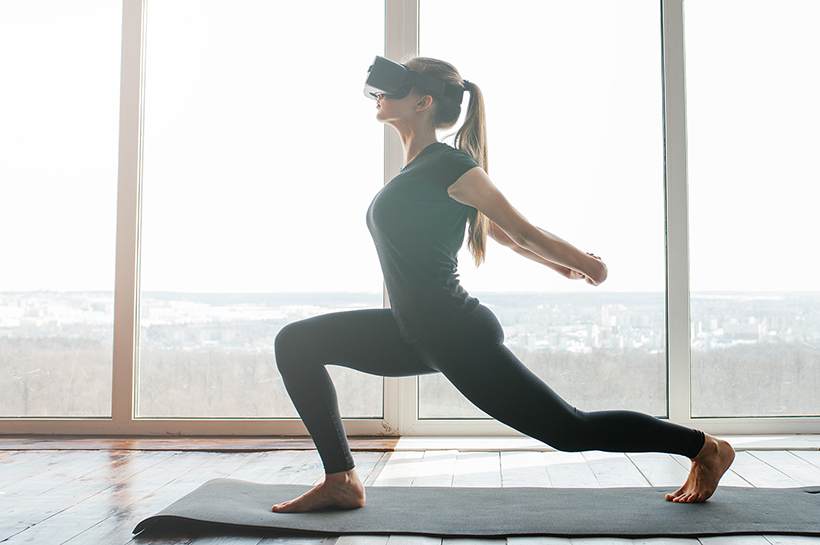 Woman Doing Meditation with VR Set on Yoga Mat, Technology Stock